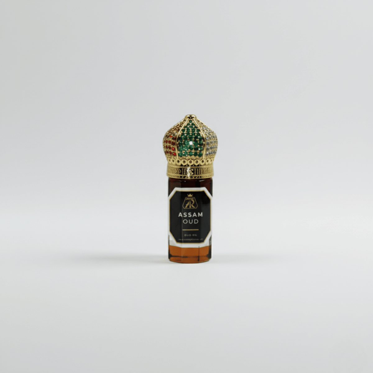 Assam Oud perfume bottle with decorative cap on a light gray background