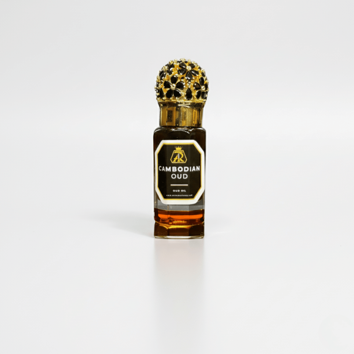 Bottle of Cambodian Oud perfume with a gold cap on a white background