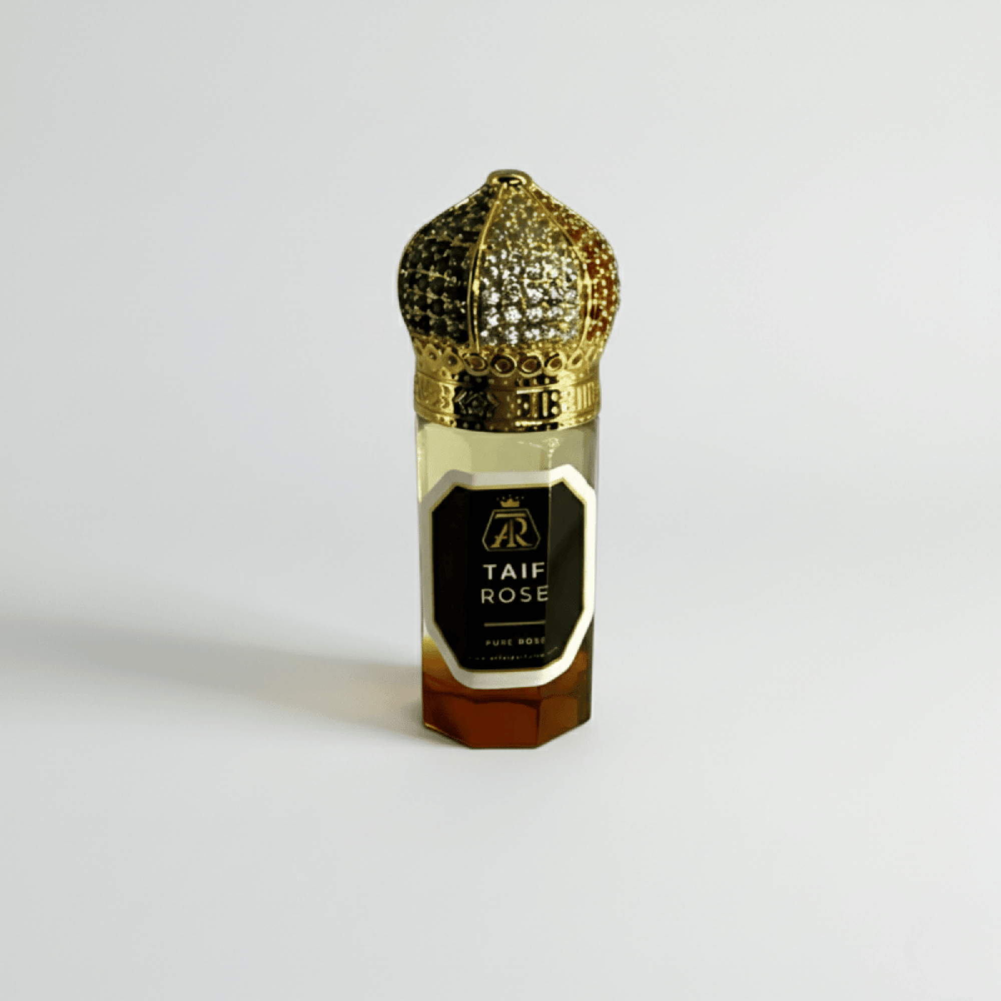 Perfume bottle labeled 'Taif Rose' with a gold cap on a light gray background