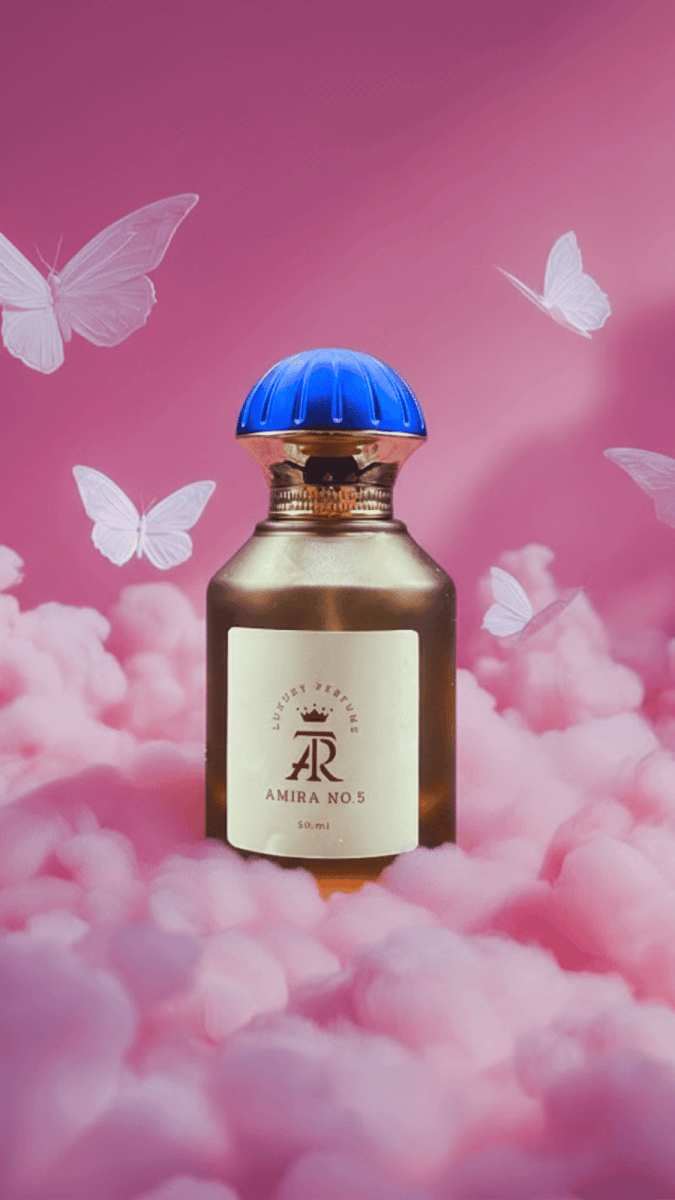 Perfume bottle with blue cap on pink fluffy background with butterflies