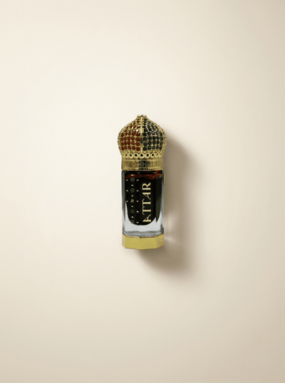 Perfume bottle with decorative cap on a beige background