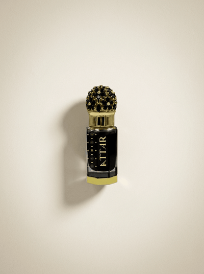 Perfume bottle with decorative cap on a beige background