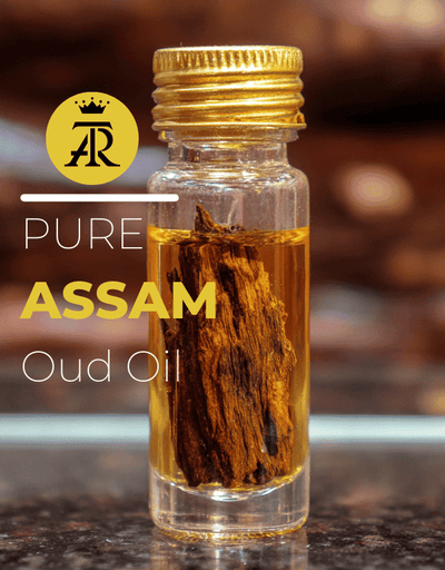 Bottle of Pure Assam Oud Oil with a gold cap on a blurred background