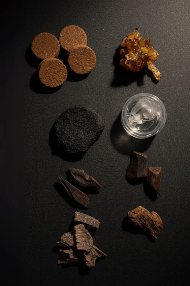 Collection of various dark brown and black substances on a black surface