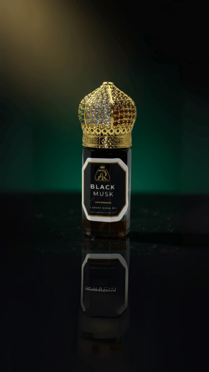 Black Musk – Extrait Oil - attar perfumeBlack Musk – Extrait OilmuskAttar Perfumeattar perfumeBottle of Black Musk perfume with a gold crown on a reflective surface3 Ml