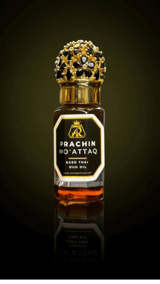 Prachin Mo’attaq – 20 Years Aged Thai Oud Oil - attar perfumePrachin Mo’attaq – 20 Years Aged Thai Oud Oiloud oilAttar Perfumeattar perfumePrachin Mo'Attaq oud oil bottle with decorative cap on a dark background6 ML